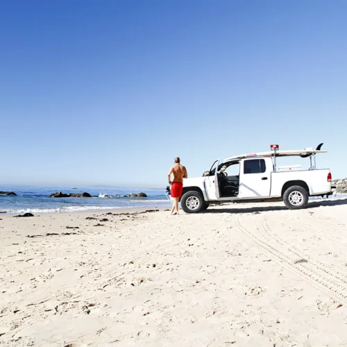 man and white truck on california coast
