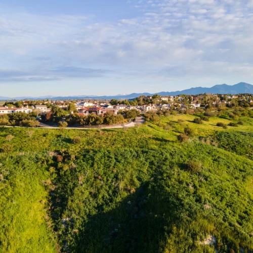 rolling green hills with residential neighborhood