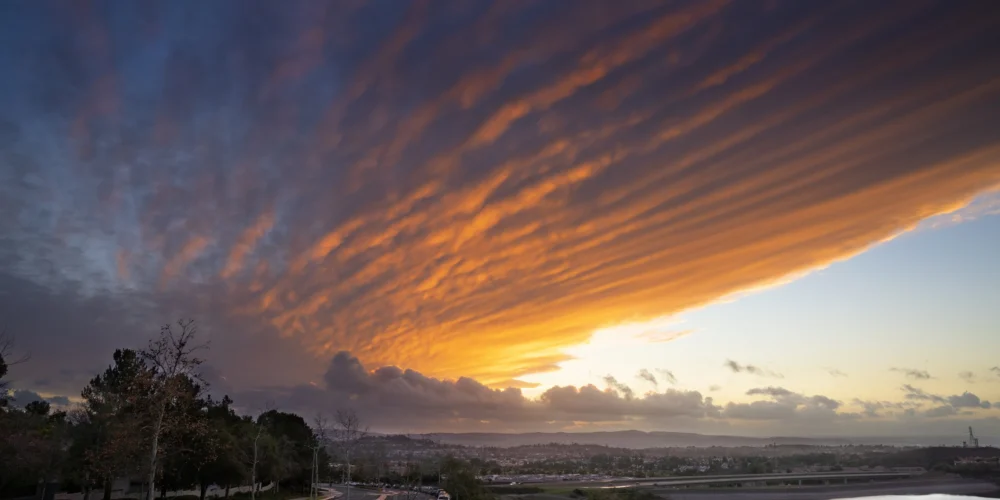 southern californian sunset over cityscapes and reservoir
