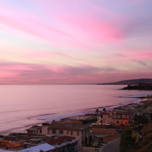 Aerial view of Californian coastal development & beach at sunset