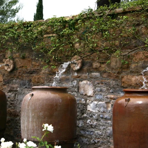 fountains and vine-covered wall