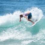 surfer on a wave crushes the lip