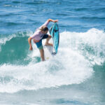 surfer on a wave crushes the lip