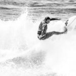 surfer on a wave crushes the lip