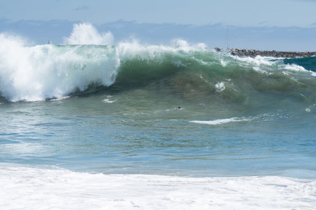 big surf with bodysurfers in wave