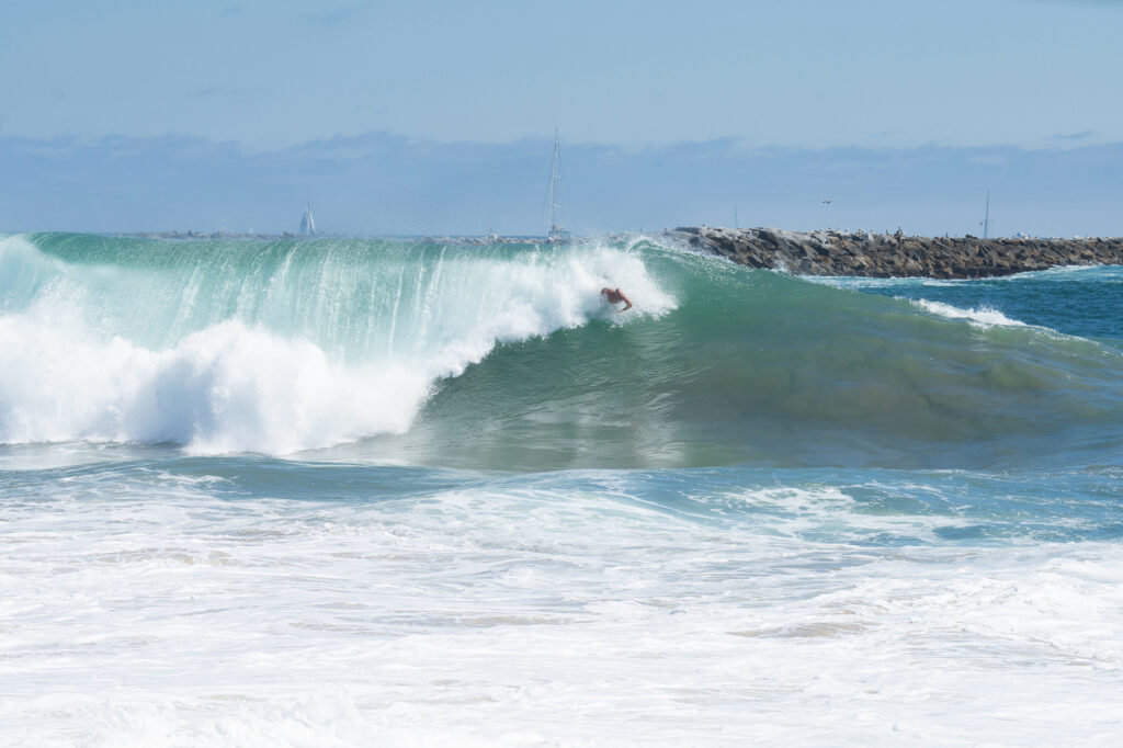 big surf with bodysurfers in wave