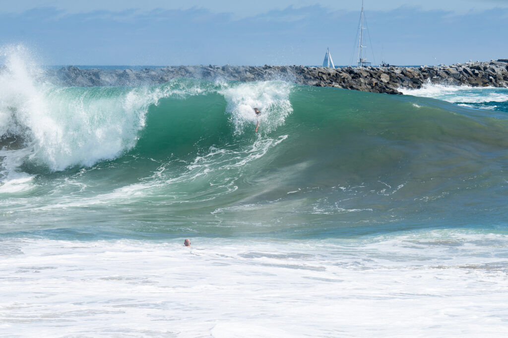 big surf with bodysurfers in wave